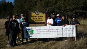 participants & volunteers at the sign